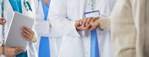 Doctors and nurses stacking hands. Isolated on white