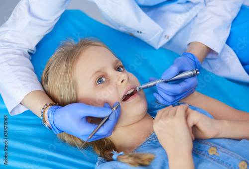 Little girl sitting in the dentists office.