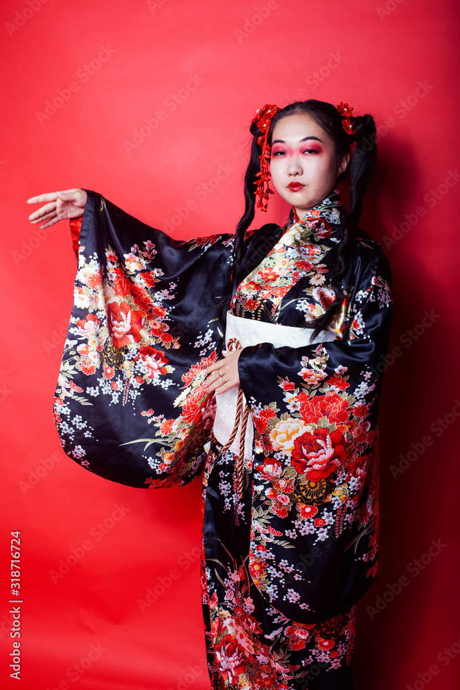 young pretty geisha on red background posing in kimono, oriental concept young pretty geisha on red background posing in kimono, oriental concept