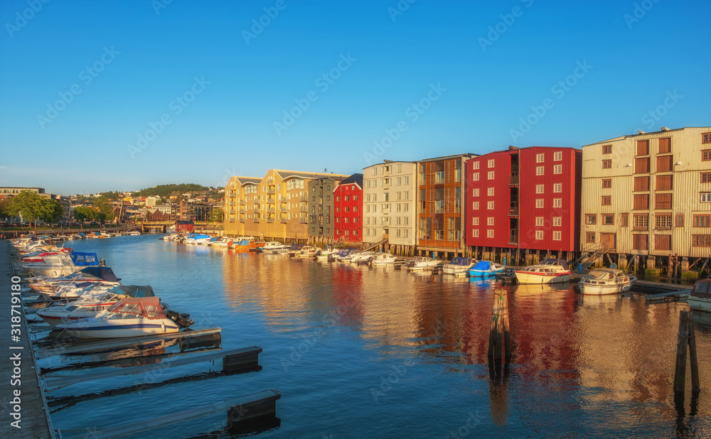 Obraz premium TRONDHEIM, NORWAY - july, 2019: Colorful old houses at the Nidelva river embankment in Trondheim, Norway.