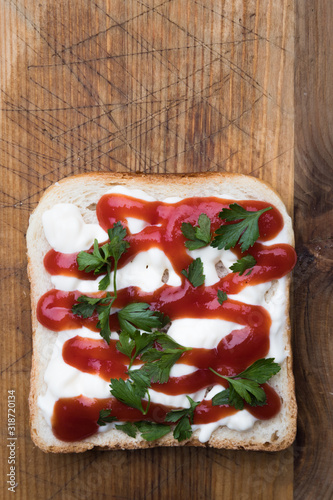 Slice of toast breadwith ketchup and mayo spread photo