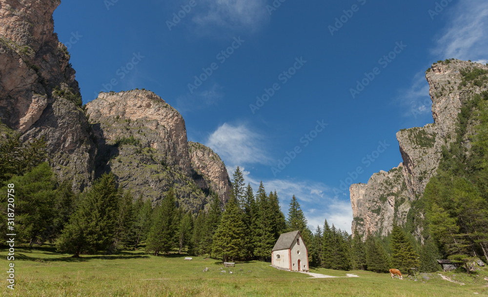 An isolated little chapel (St. Silvester) among the woods in the Italian Dolomites