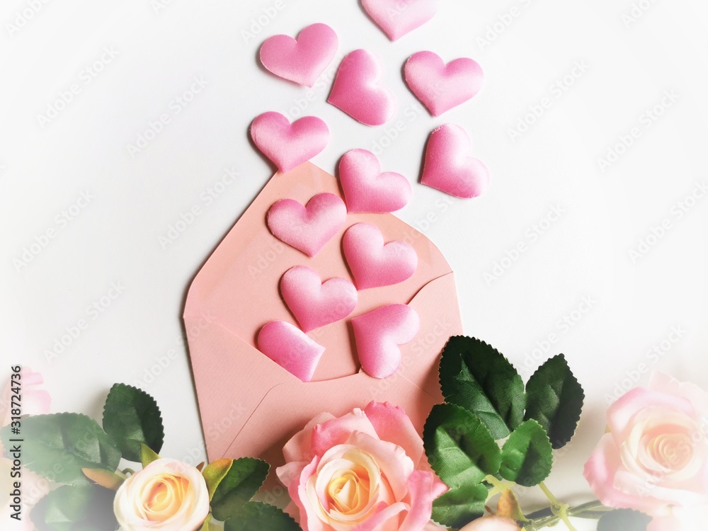 Valentine's day background. Greeting card with roses and pink hearth in envelope. Top view, copy space. 