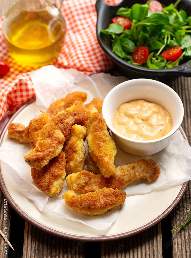 Homemade breaded chicken fingers nuggets with lettuce Homemade breaded chicken fingers nuggets with lettuce