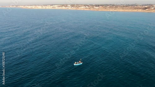 Fishermen on the small boat, in the sea, in Puglia