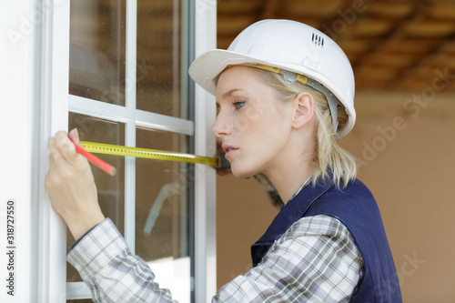 a female worker measuring window