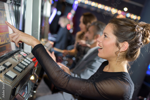 beautiful woman playing slot machine