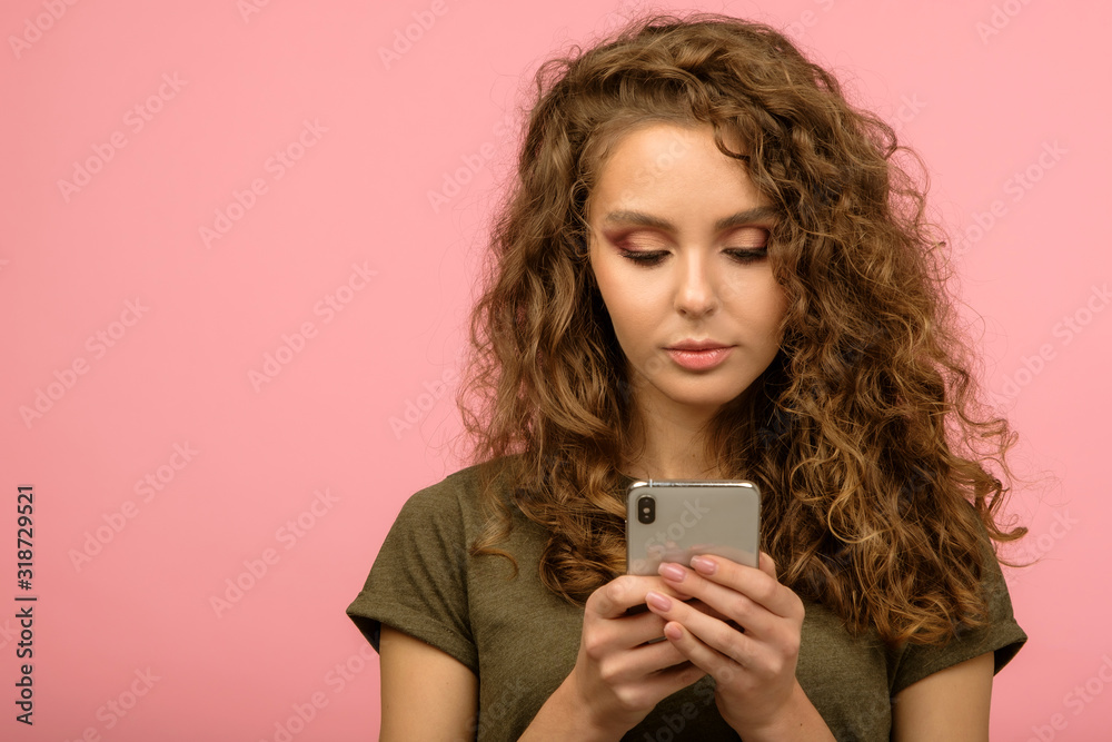 Closeup studio portrait of pretty student with smartphone Closeup studio portrait of pretty student with smartphone