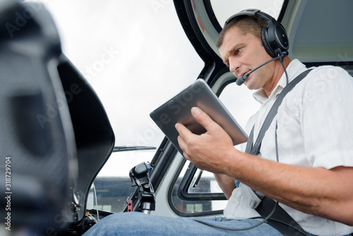 male using a tablet in a helicopter