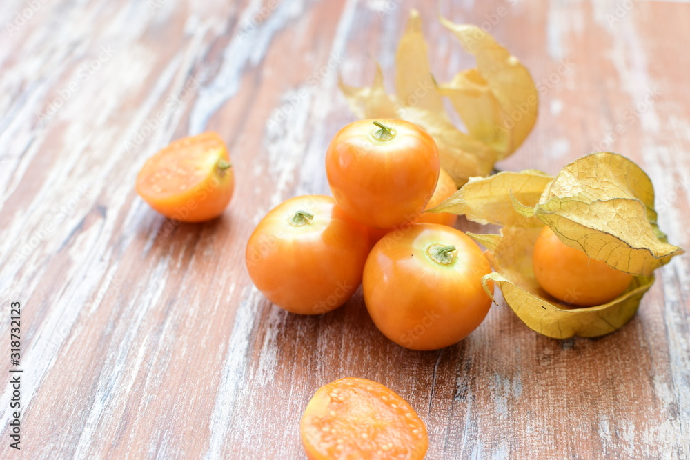 natural cape gooseberry on wooden background natural cape gooseberry on wooden background