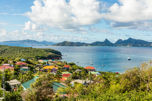 Residential houses at the bay, Mayreau island panorama with Union island in the background, Saint Vincent and the Grenadines photo