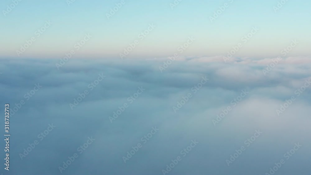 Flight above fog clouds at sunrise Flight above fog clouds at sunrise