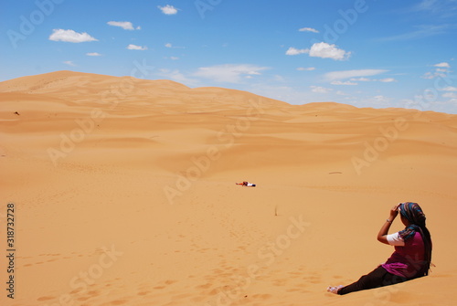 Young Woman Gazing Across the Sahara Desert near Merzouga, Morocco