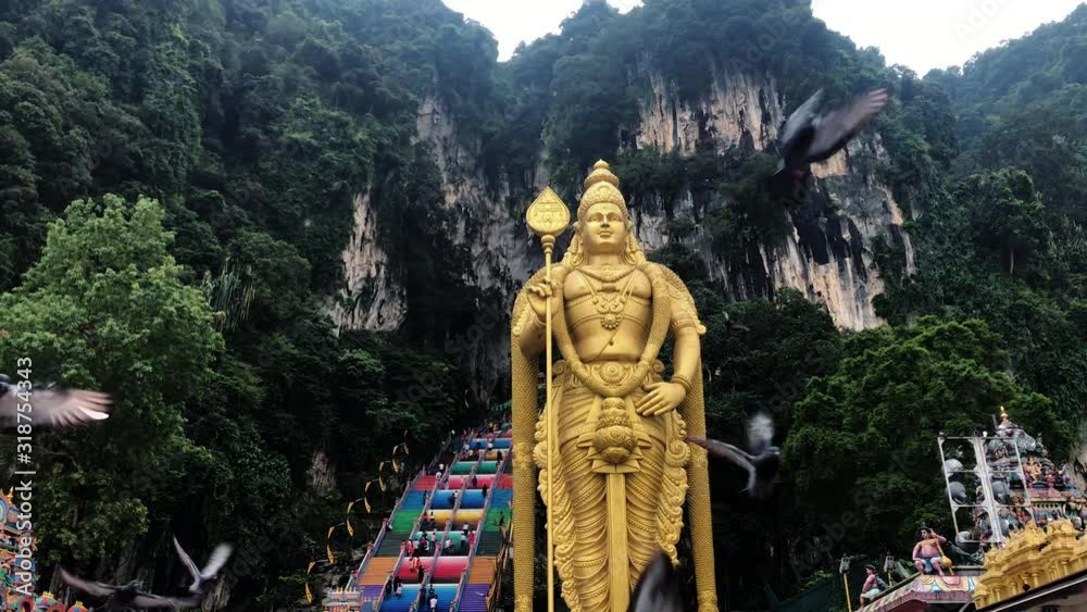 flock of pigeons eating wheat grains being fed in Batu caves temple in slow motion, Malaysia flock of pigeons eating wheat grains being fed in Batu caves temple in slow motion, Malaysia