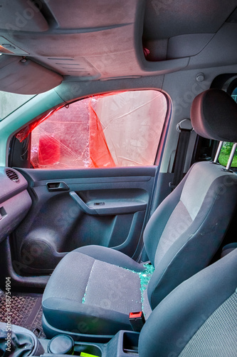 Car With Broken Door Window. Taped with Protective Film Before Repairing. Inside Car View. photo