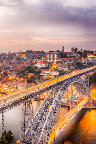 Travel Concepts. Dom Luis I Bridge in Porto in Portugal During Golden Hour With Passing Metro Lanes.