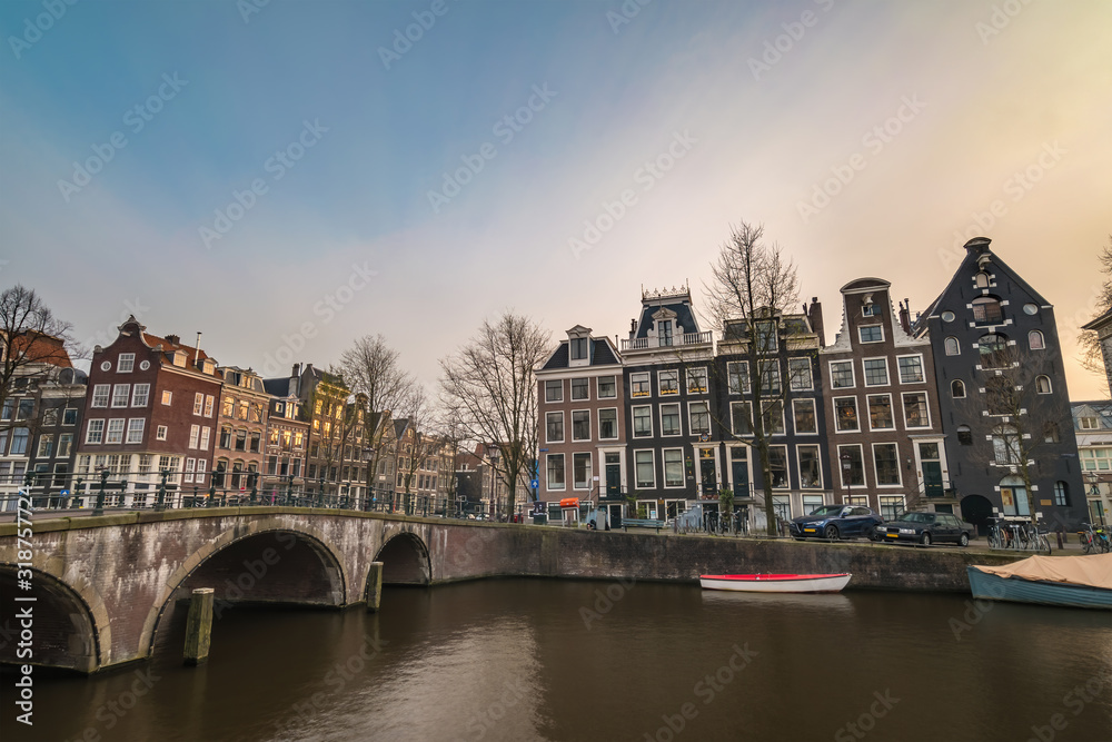 Amsterdam Netherlands, city skyline at canal waterfront and bridge with traditional house