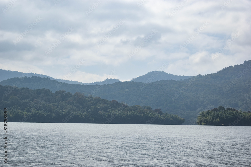 A scenic view of mountains, trees and clouds A scenic view of mountains, trees and clouds