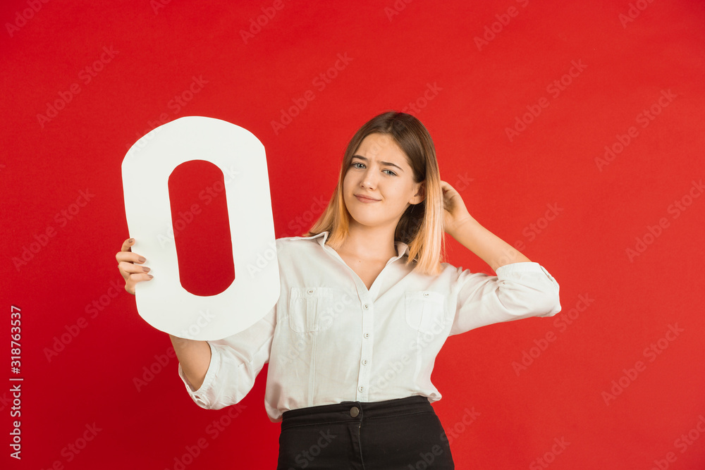 O for lOve. Valentine's day celebration, happy, cute caucasian girl holding letter on red studio background. Concept of human emotions, facial expression, love, relations, romantic holidays. O for lOve. Valentine's day celebration, happy, cute caucasian girl holding letter on red studio background. Concept of human emotions, facial expression, love, relations, romantic holidays.