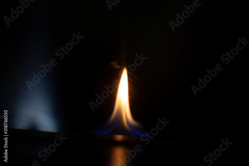 Tongue of fire flame in the dark. Ignition of oxygen in space. Fiery background. Fire of ether in the absence of light. Abstract fire heat background. Single fire. The ignition gel is on.