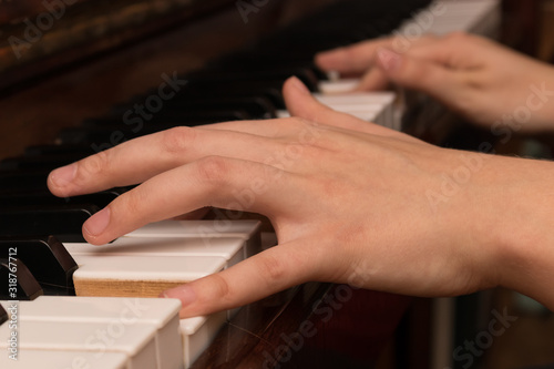 Hands of a girl playing the piano close-up © Evgeniya