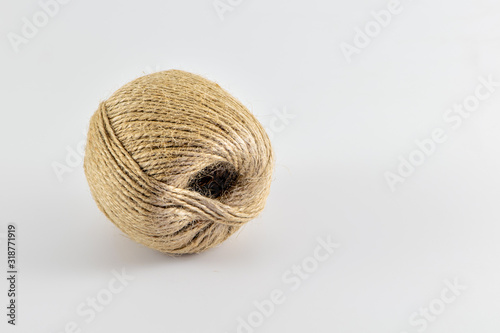 Jute skein isolated on white. Jute twine close-up shot with copy space. Natural brown rope.