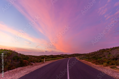 Fototapeta Naklejka Na Ścianę i Meble -  Beautiful glowing sunset ver scenic coastal road in Australia