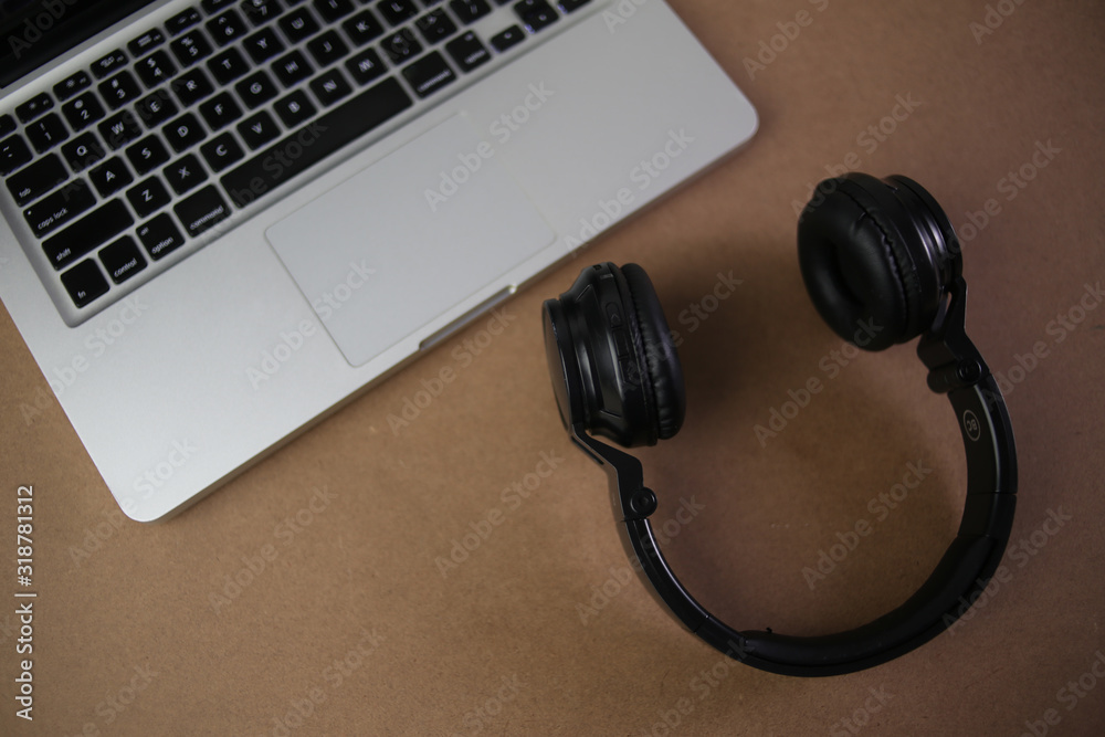 Audio, video and photography business office with equipment such as laptop, mobile phone, headphones and camera with photographic accessories Audio, video and photography business office with equipment such as laptop, mobile phone, headphones and camera with photographic accessories