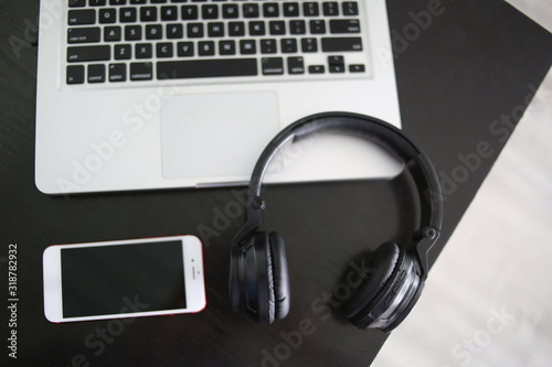 Audio, video and photography business office with equipment such as laptop, mobile phone, headphones and camera with photographic accessories