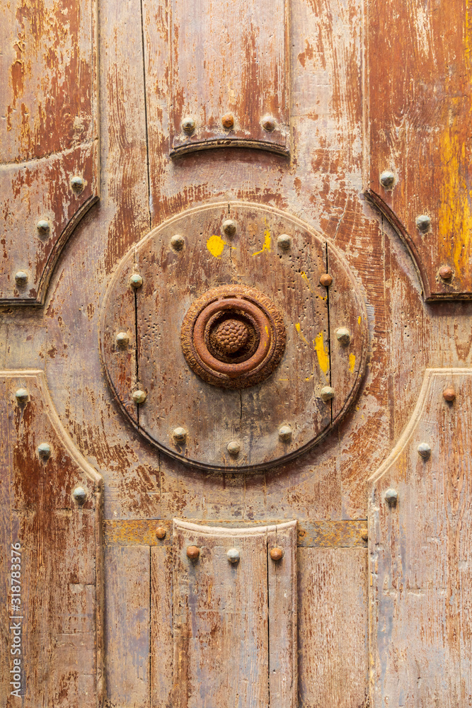 Italy, Sicily, Palermo Province, Cefalu. Detail of an exterior wooden door on the Cefalu Cathedral, a UNESCO World Heritage site.