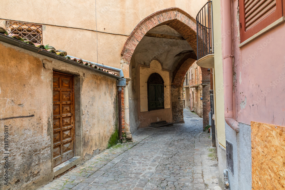 Italy, Sicily, Palermo Province, Castelbuono. Archway over cobblestone street in the town of Castelbuono.
