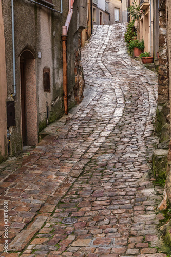 Italy, Sicily, Palermo Province, Geraci Siculo. Winding narrow cobblestone street in the town of Geraci Siculo.