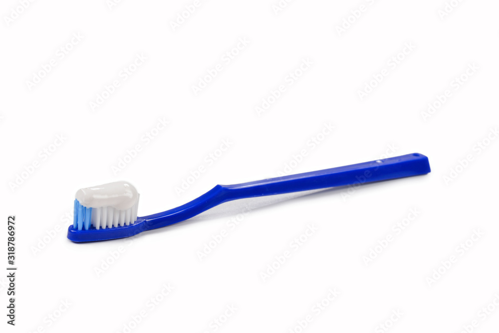 Blue toothbrush with toothpaste in her hand isolated on white background. Blue toothbrush with toothpaste in her hand isolated on white background.