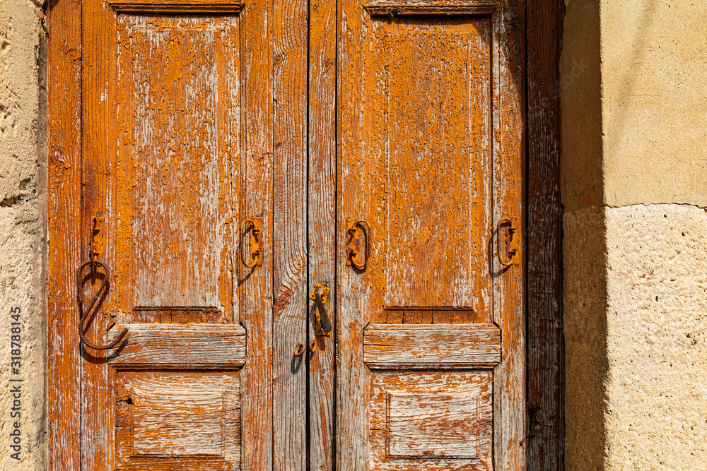 Italy, Sicily, Messina Province, Montalbano Elicona. Peeling paint on old wooden doors in the medieval hill town of Montalbano Elicona.