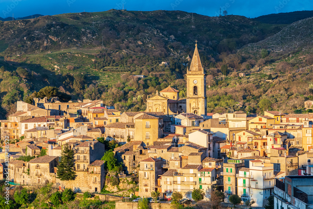 Italy, Sicily, Messina Province, Francavilla di Sicilia. The medieval hill town of Francavilla di Sicilia at sunset.