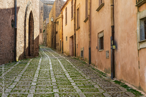 Fototapeta Naklejka Na Ścianę i Meble -  Italy, Sicily, Trapani Province, Erice. A narrow cobblestone street in the ancient hill town of Erice.