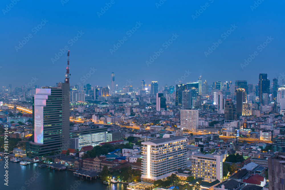 Bangkok city skyline in downtown district at night blue hour time.