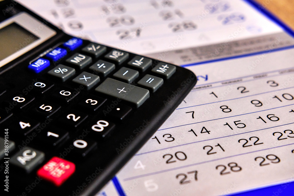Blue calendar with black calculator Counting and planning. Blue calendar with black calculator Counting and planning.