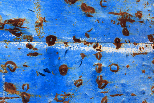 Abstract background of peeling white paint on a blue wall, rust on a cold wall © Natalia