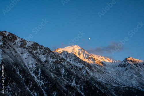 Reflection of moon by mountains in winter