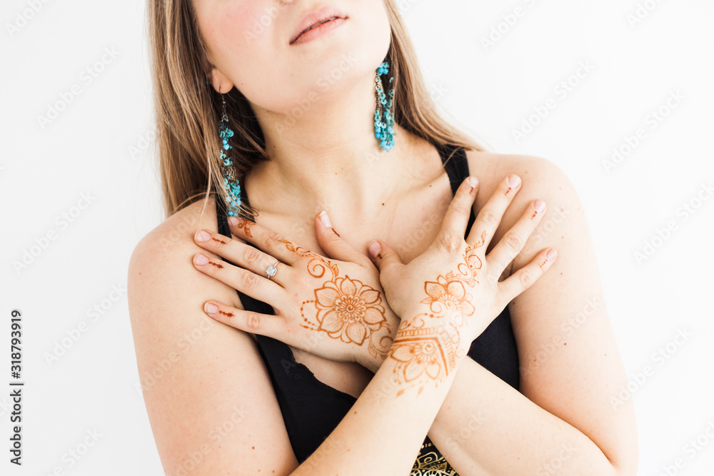 Girl of European appearance, henna drawing on hands, mahendi, girl in light clothes, yoga, spiritual development