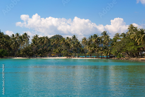 Tropical island sand beach on the sea. Blue sky with clouds. © anya babii