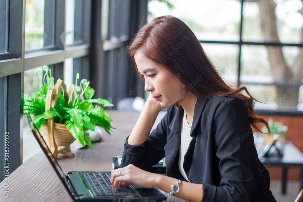 Asian business women using notebook for working and businesswoman serious about the work done until the headache Asian business women using notebook for working and businesswoman serious about the work done until the headache