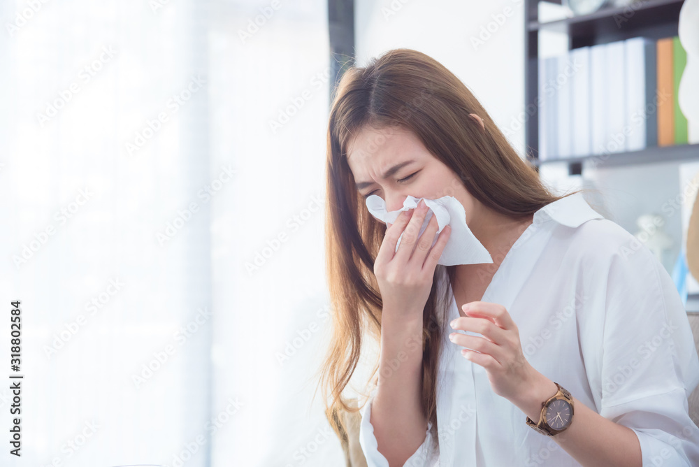 Young asian beautiful woman having running nose,wipe her nose by tissue paper. Young asian beautiful woman having running nose,wipe her nose by tissue paper.
