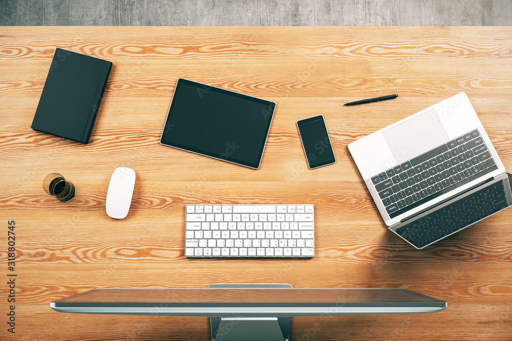 Top view of wooden desk with computer, laptop and other working accessories. Workplace concept. 3D Rendering Top view of wooden desk with computer, laptop and other working accessories. Workplace concept. 3D Rendering
