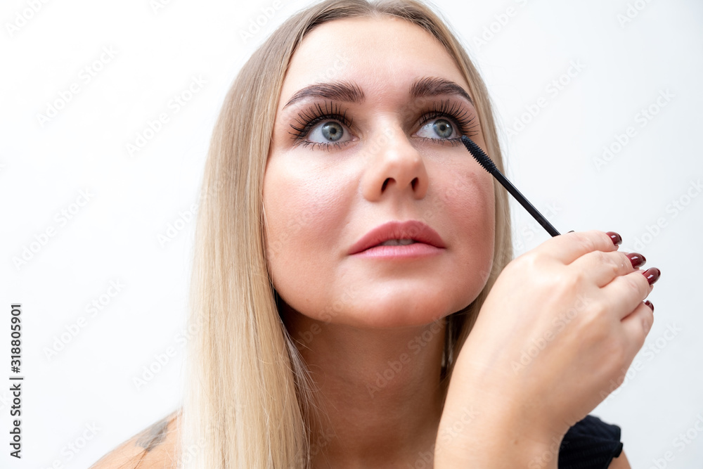 Female eyes with extreme long eyelashes and a mascara brush. Makeup, cosmetics, beauty.