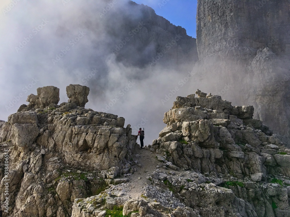 A hiker hiking in the alps mountains lonely dare alone