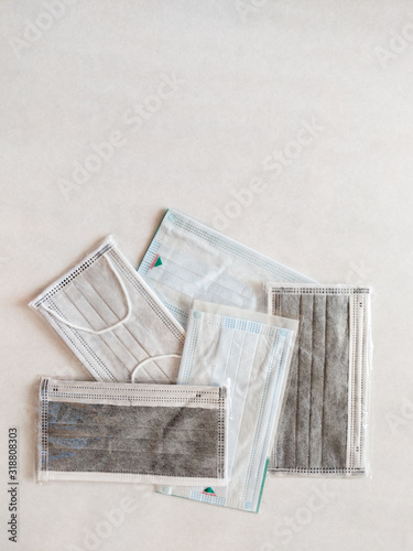 A bunch of disposable surgical face masks on a white background