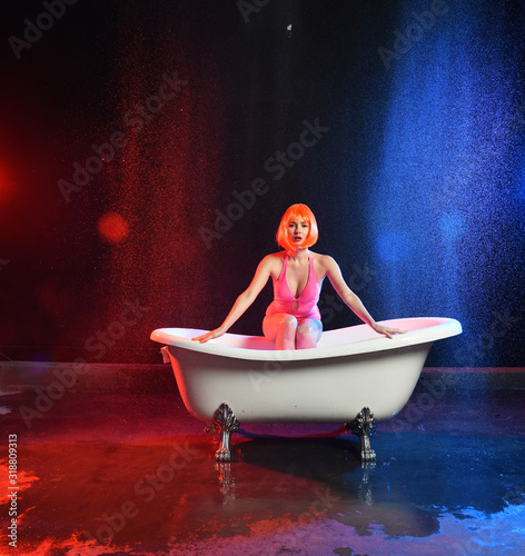 beautiful girl with red hair posing in a white bath