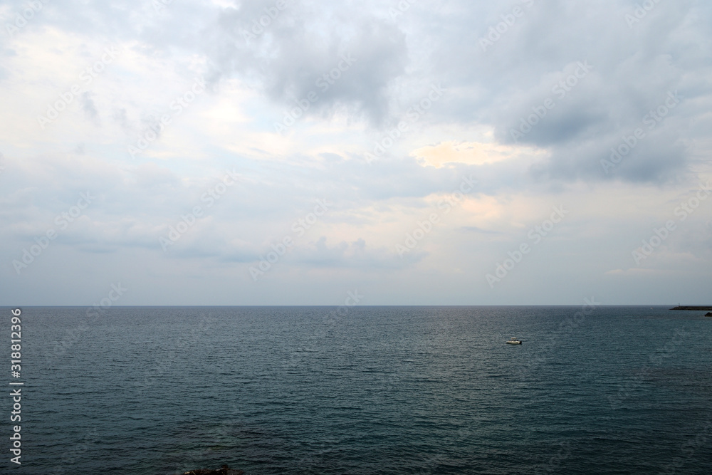 Overcast sky over the sea on a summer evening near the coast of Sicily. Natural background